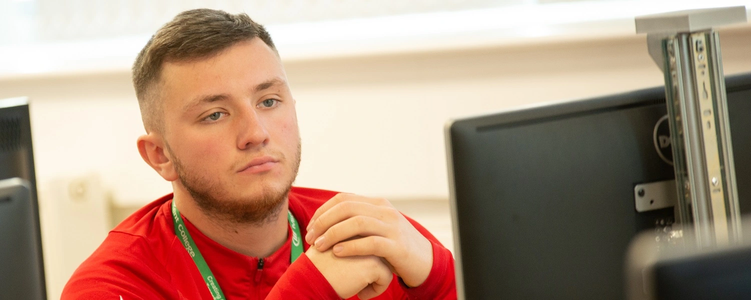 Construction apprentice at a computer